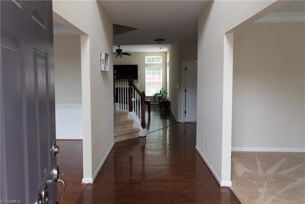 3036 Sycamore Point Trail High Point, NC 27265 - Photo 3 of 30 Entrance hosts 2-story foyer and wood floors. Living room to the right, dining room to the left.