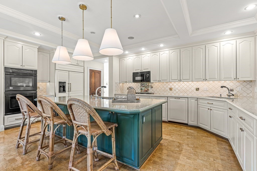 47 Cypress Road Wellesley, MA 02481 - Photo 12 of 36 a kitchen with stainless steel appliances kitchen island granite countertop a sink a stove and cabinets