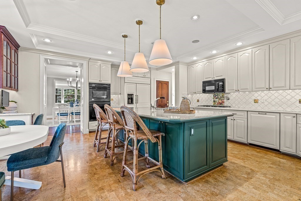 47 Cypress Road Wellesley, MA 02481 - Photo 13 of 36 a kitchen with a table chairs sink and cabinets