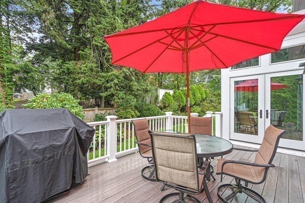 47 Cypress Road Wellesley, MA 02481 - Photo 33 of 36 a view of a deck with table and chairs under an umbrella