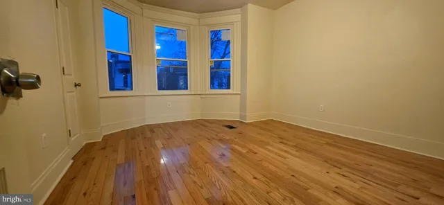 a view of hallway with wooden floor