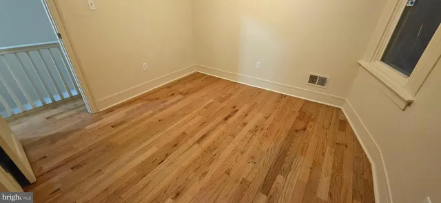 a view of a room with wooden floor