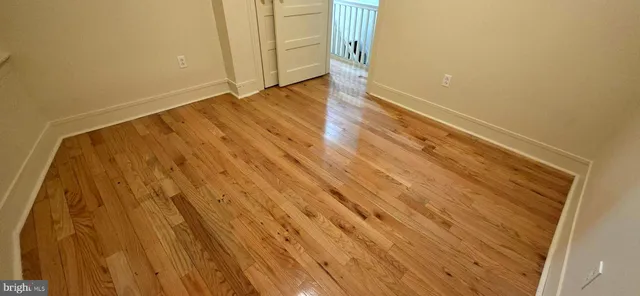 a view of wooden floor and brick walls