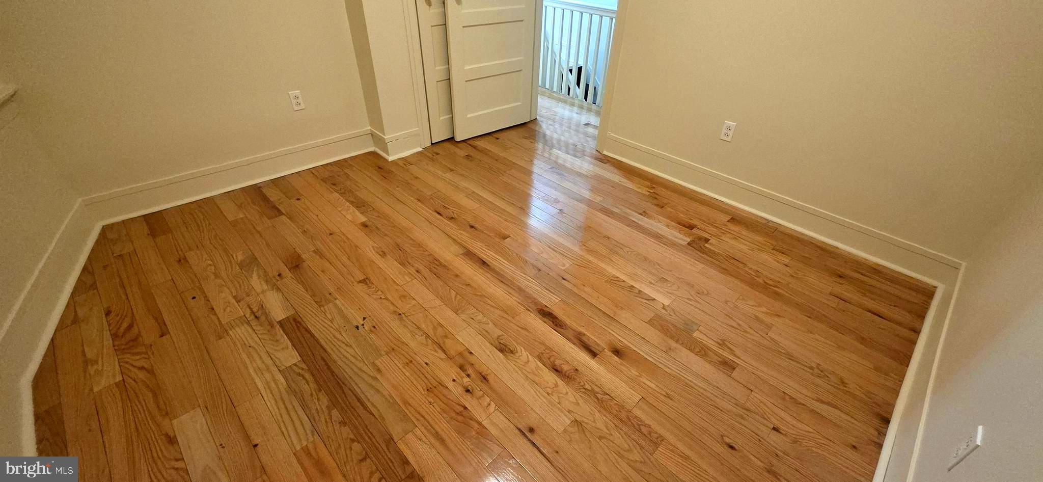 4527 North Carlisle Street Philadelphia, PA 19140 - Photo 20 of 28 a view of an empty room with wooden floor