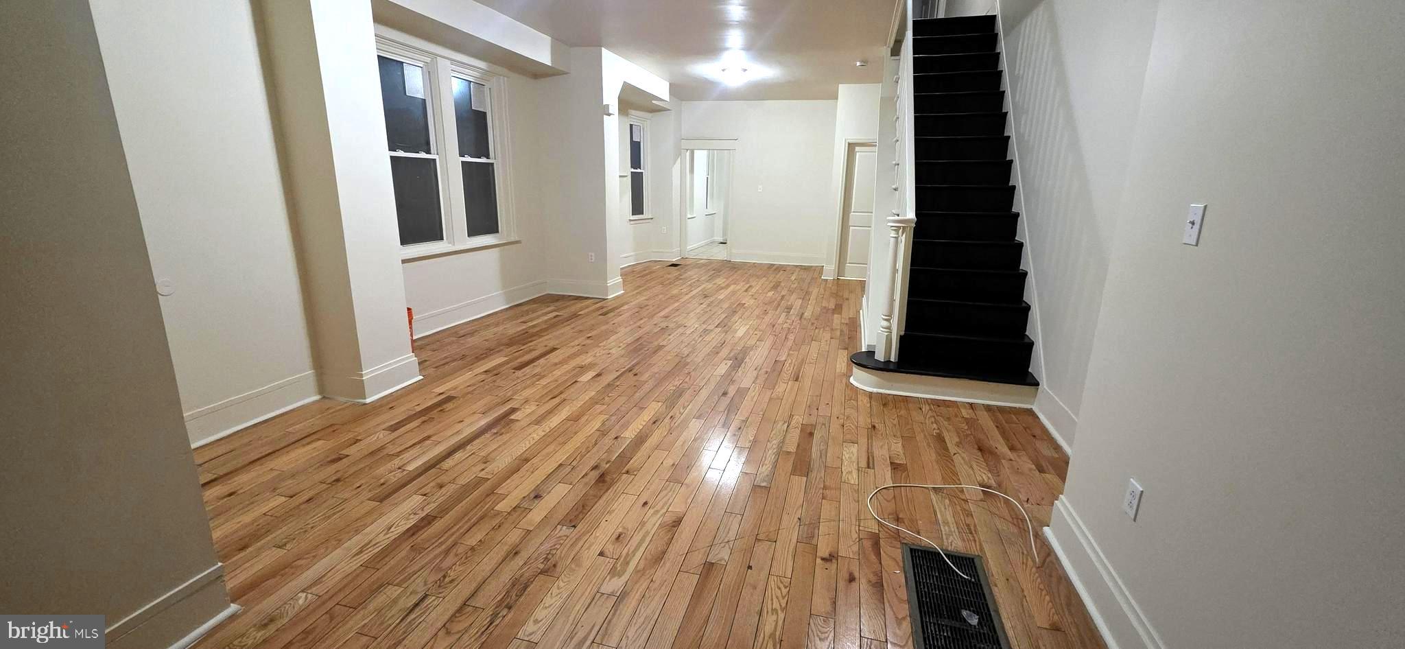 4527 North Carlisle Street Philadelphia, PA 19140 - Photo 4 of 28 a view of a hallway with wooden floor and staircase