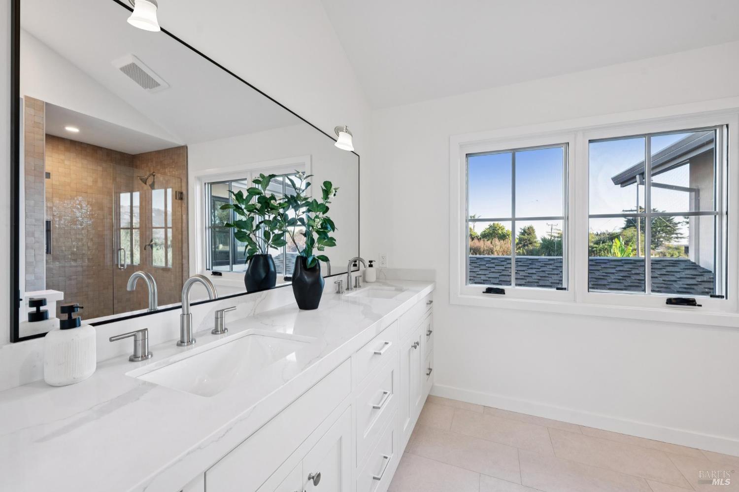 185 Elm Road Bolinas, CA 94924 - Photo 18 of 43 a bathroom with a sink and a large mirror next to a window