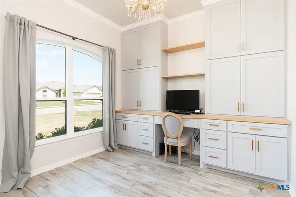 a room with a chair and a flat screen tv