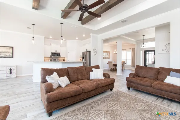 a living room with furniture and kitchen view