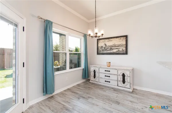 a view of a bedroom with baby crib and a window