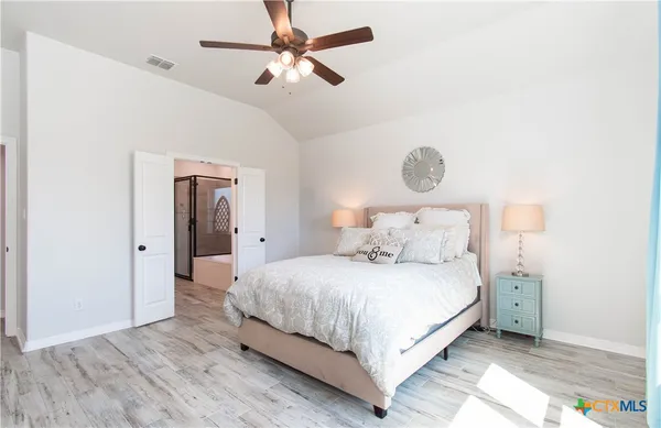 a bedroom with a bed and a chandelier