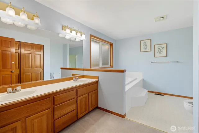 a bathroom with a double vanity sink and a mirror