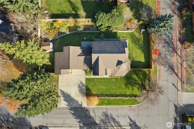 an aerial view of a house with outdoor space and garden