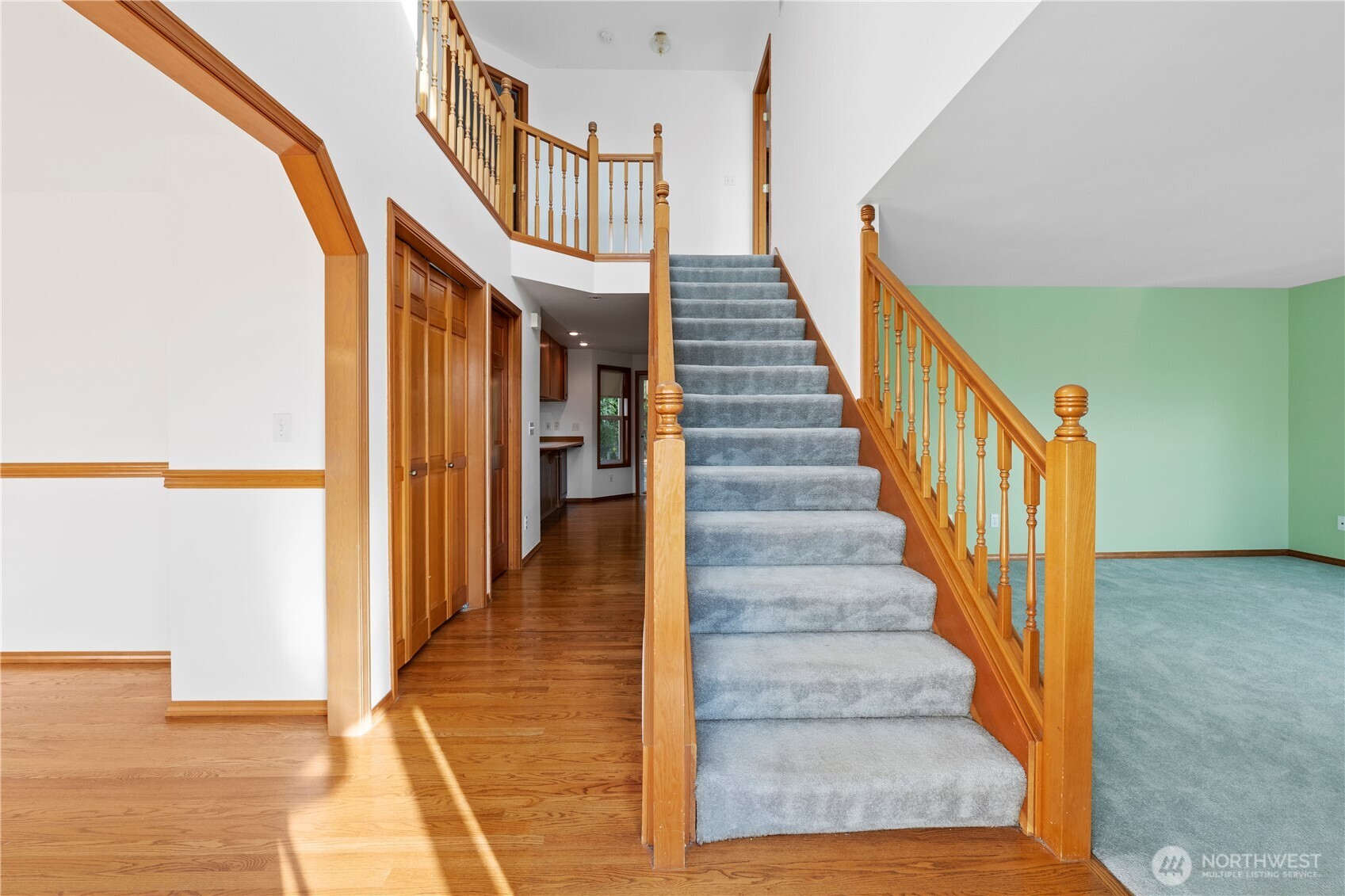 14010 282nd Lane Northeast Duvall, WA 98019 - Photo 4 of 34 a view of staircase with lots of frames on wall and a large window