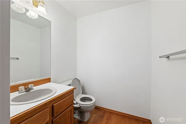 a bathroom with a sink a toilet and a mirror