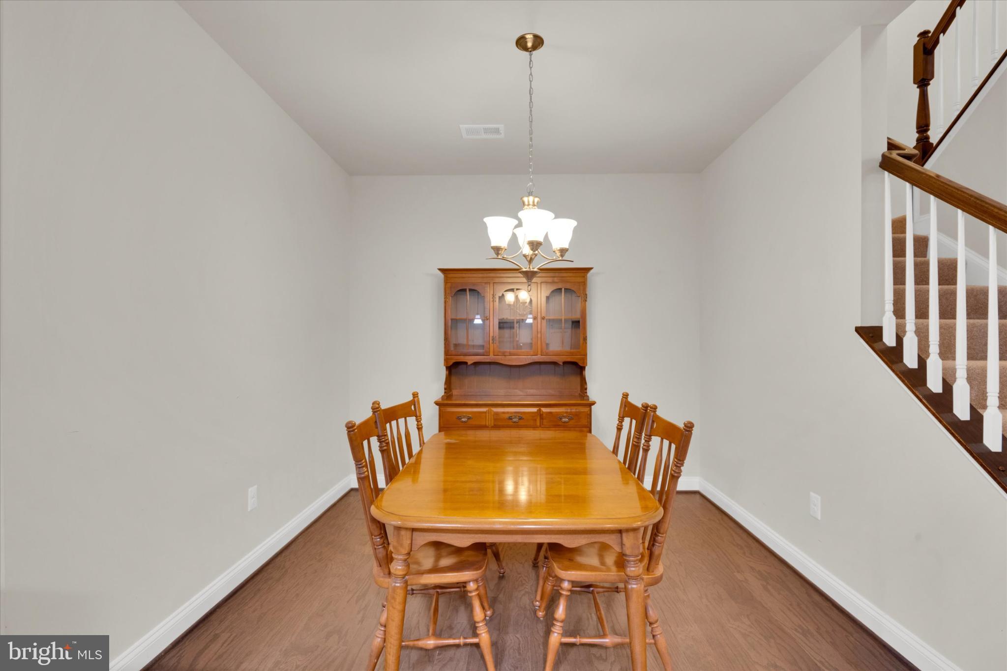 1219 Beaver Tree Drive Odenton, MD 21113 - Photo 12 of 48 a view of a dining room with furniture and wooden floor