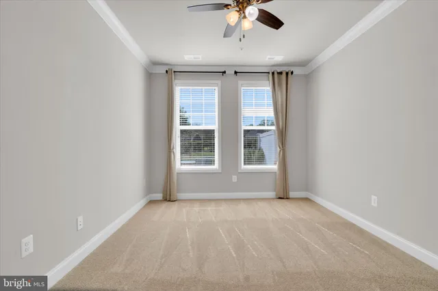 a view of livingroom with a ceiling fan and window