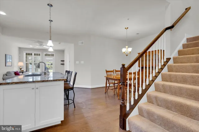 a kitchen with stainless steel appliances kitchen island a chandelier