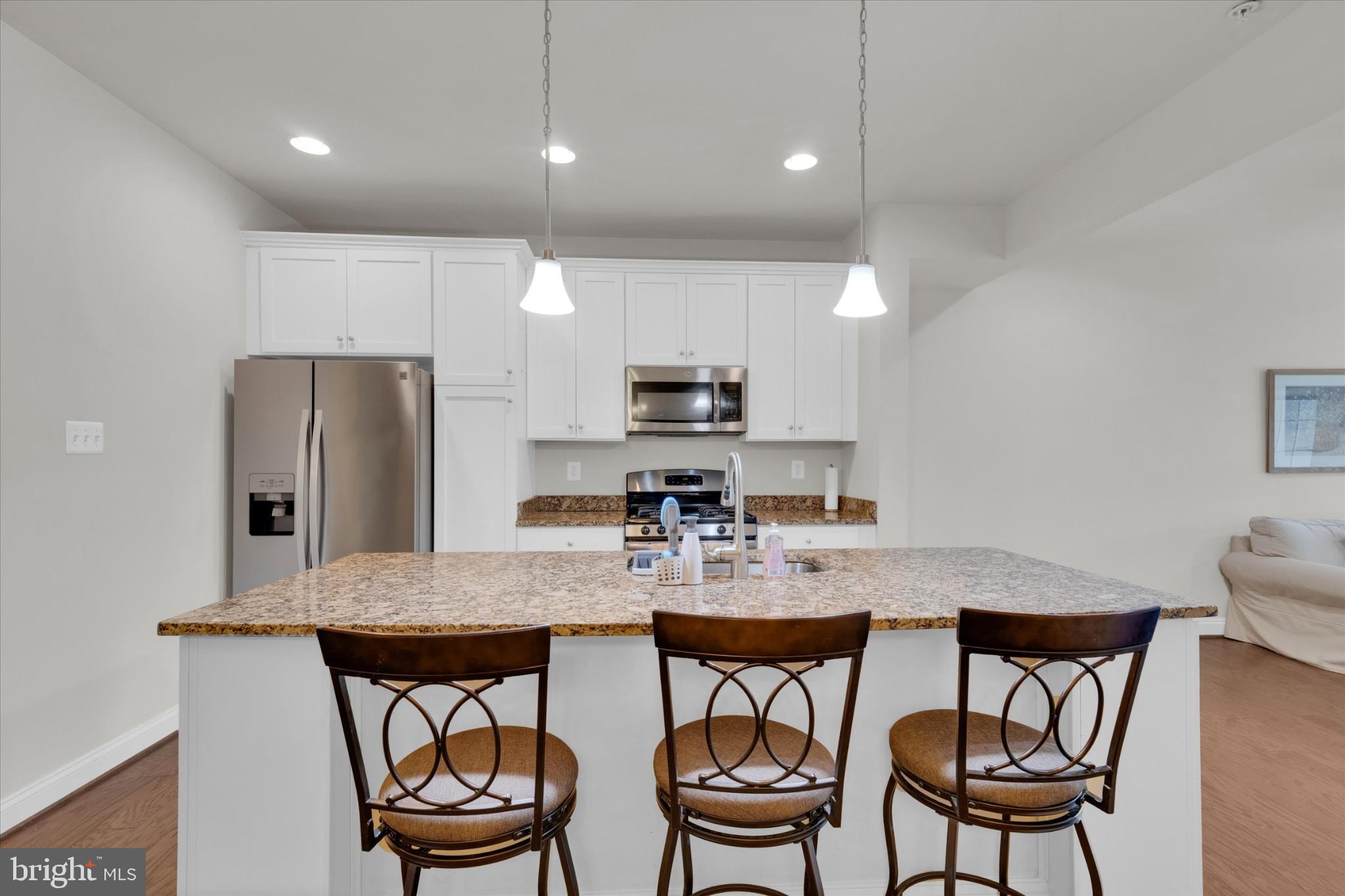 1219 Beaver Tree Drive Odenton, MD 21113 - Photo 10 of 48 a kitchen with a dining table chairs and refrigerator