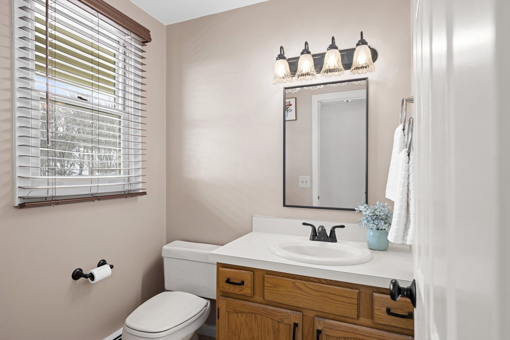 7 Fieldstone Drive, Unit 7 Upton, MA 01568 - Photo 11 of 30 a bathroom with a sink vanity granite toilet and a mirror