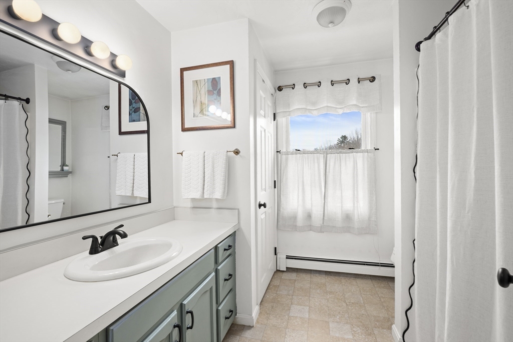 7 Fieldstone Drive, Unit 7 Upton, MA 01568 - Photo 16 of 30 a bathroom with a granite countertop sink mirror and a