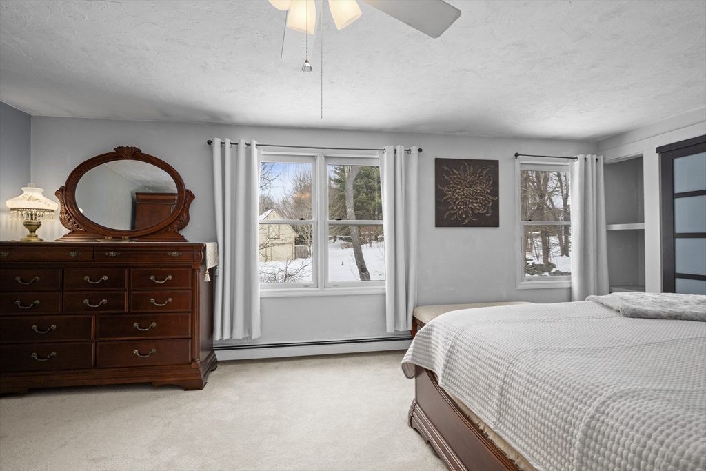 7 Fieldstone Drive, Unit 7 Upton, MA 01568 - Photo 19 of 30 a bedroom with a bed and a dresser
