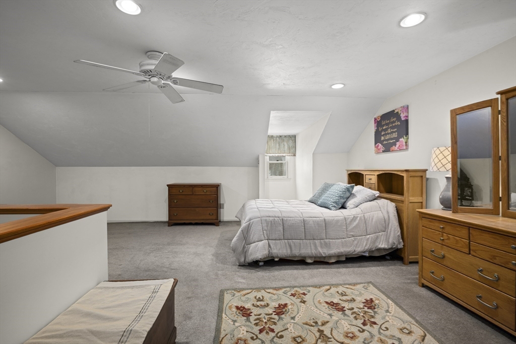 7 Fieldstone Drive, Unit 7 Upton, MA 01568 - Photo 22 of 30 a bedroom with a bed and a couch