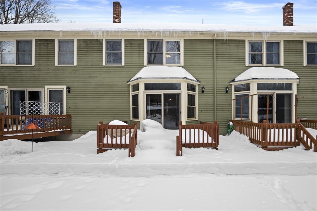 7 Fieldstone Drive, Unit 7 Upton, MA 01568 - Photo 27 of 30 a view of a brick house with large windows