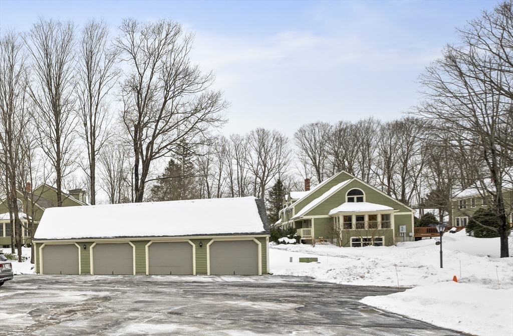 7 Fieldstone Drive, Unit 7 Upton, MA 01568 - Photo 3 of 30 a view of a white house with a yard covered in snow
