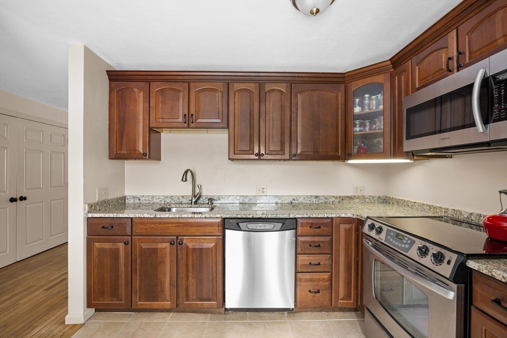 7 Fieldstone Drive, Unit 7 Upton, MA 01568 - Photo 7 of 30 a kitchen with stainless steel appliances granite countertop a stove and a microwave