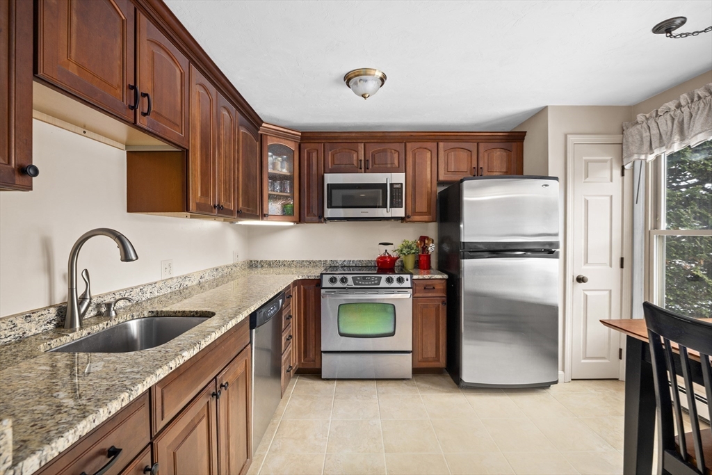 7 Fieldstone Drive, Unit 7 Upton, MA 01568 - Photo 8 of 30 a kitchen with stainless steel appliances granite countertop a refrigerator sink and stove