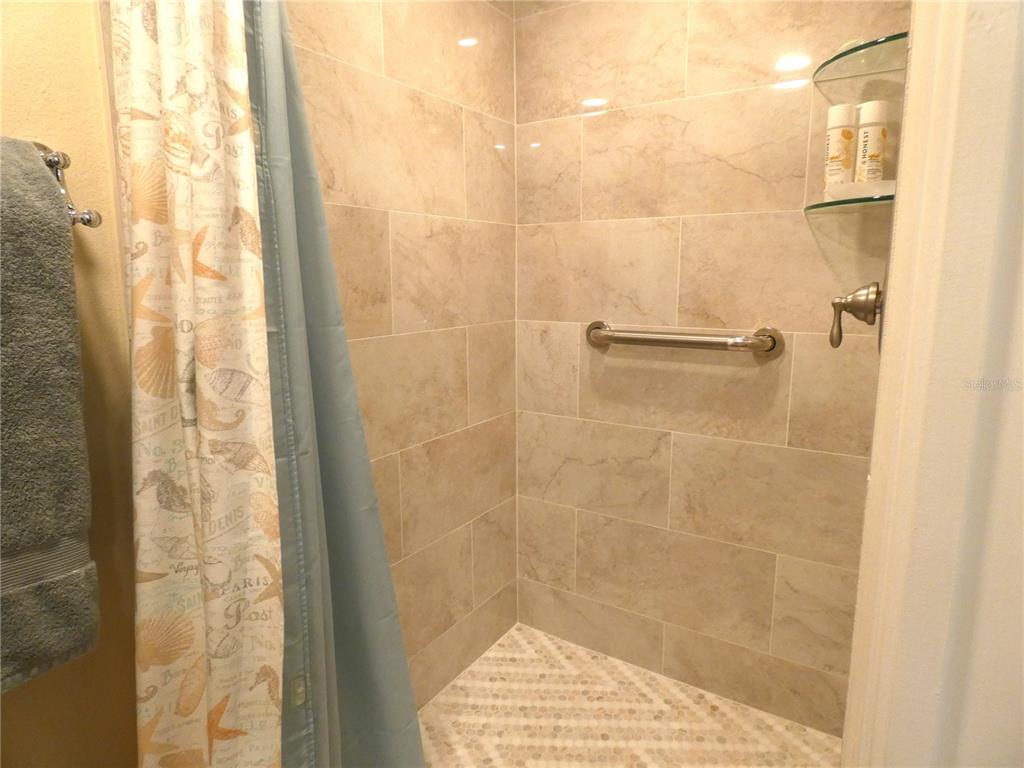 9320 Clubside Circle, Unit 2209 Sarasota, FL 34238 - Photo 11 of 27 a bathroom with a shower