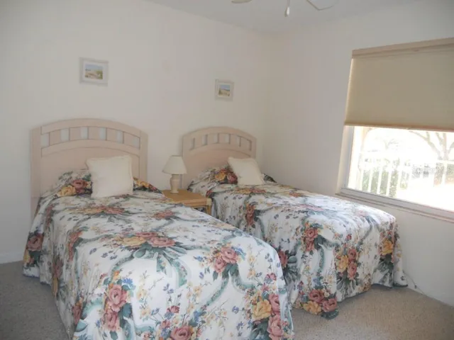 a bedroom with two beds and a window