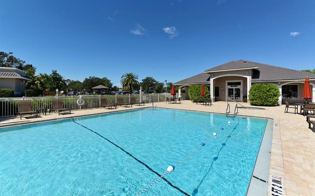 9320 Clubside Circle, Unit 2209 Sarasota, FL 34238 - Photo 24 of 27 a view of a swimming pool with an outdoor seating