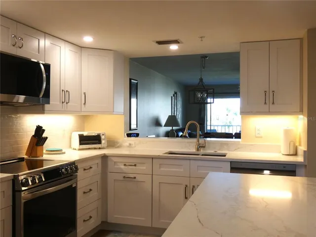 a kitchen with a sink stove and cabinets
