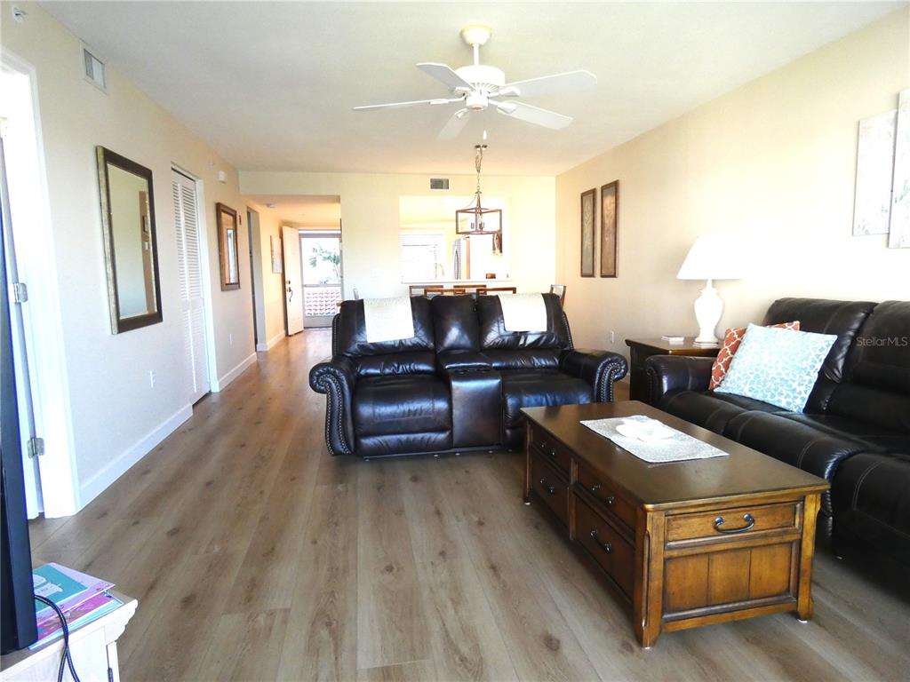 9320 Clubside Circle, Unit 2209 Sarasota, FL 34238 - Photo 7 of 27 a living room with furniture and a wooden floor