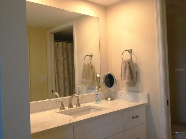 a bathroom with a double vanity sink and a mirror