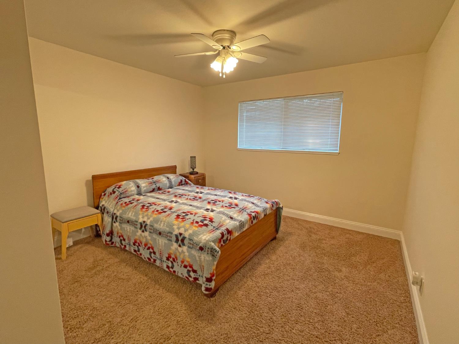 768 Excelsior Road Placerville, CA 95667 - Photo 12 of 17 a bedroom with a bed and a ceiling fan