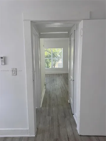 a view of hallway with wooden floor