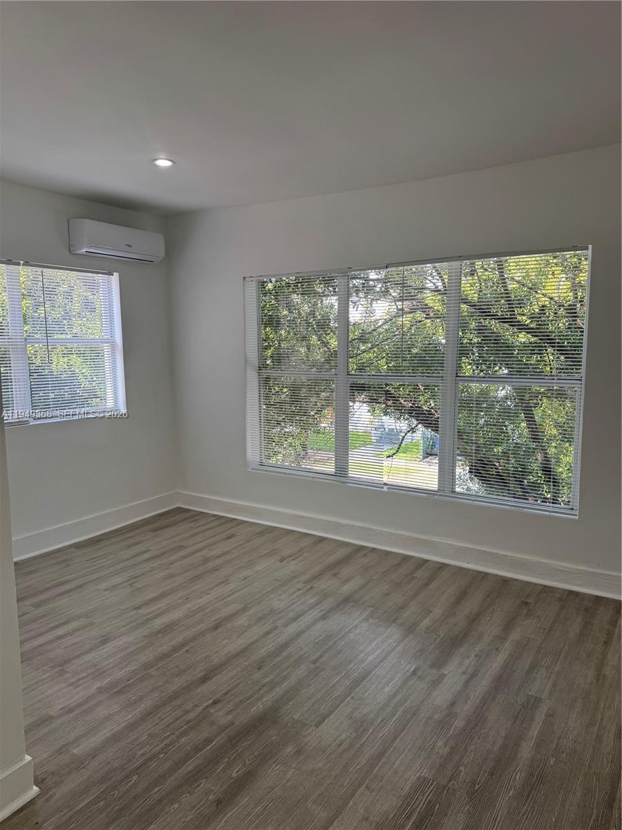 1552 Southwest 2nd Street, Unit 8 Miami, FL 33135 - Photo 10 of 10 an empty room with wooden floor and windows