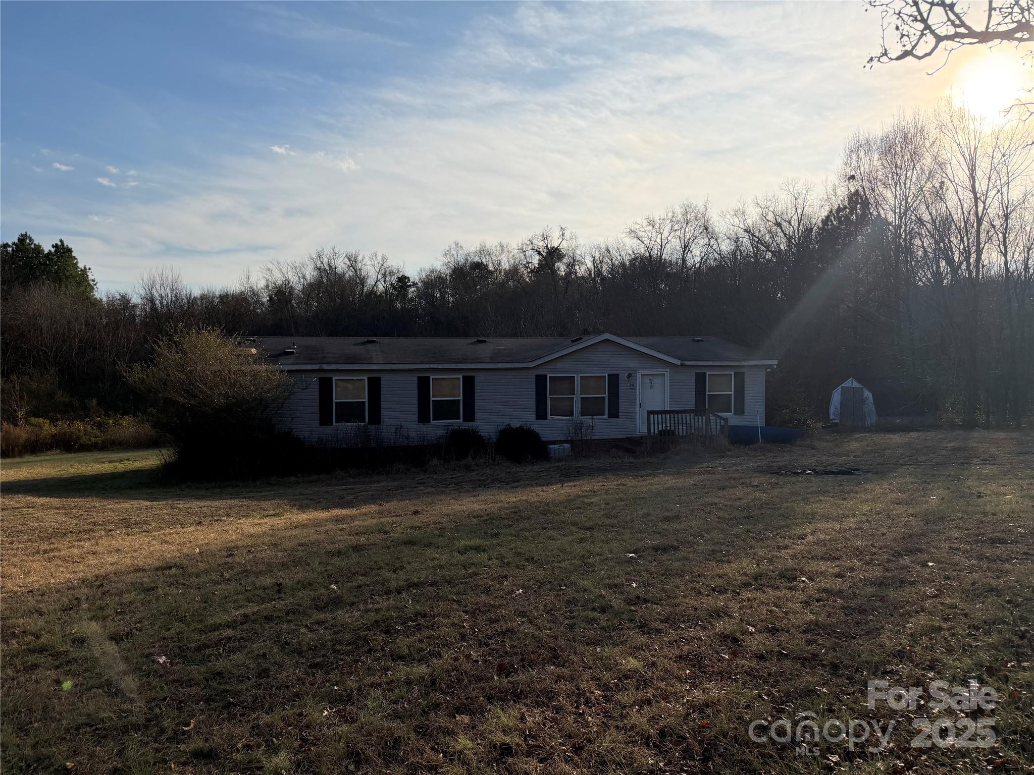 216 Pinecone Road Peachland, NC 28133 - Photo 2 of 5 a front view of a house with garden
