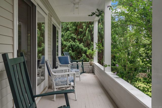a view of balcony with furniture and garden