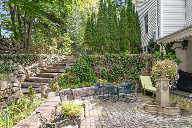a view of a patio with table and chairs and potted plants