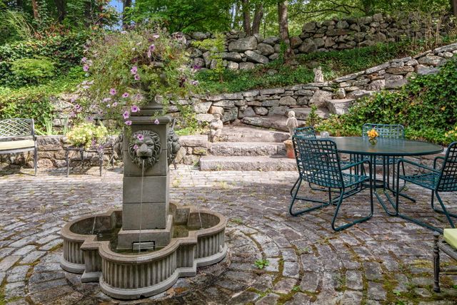 a lawn chairs and fire pit in the patio