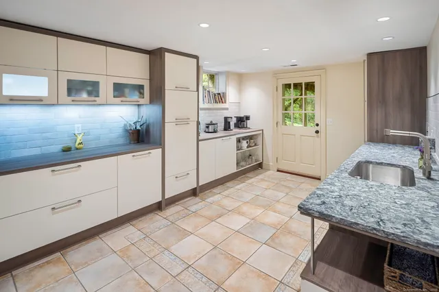 a kitchen with stainless steel appliances granite countertop a stove a sink and a refrigerator