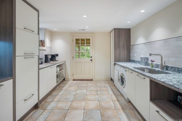 a kitchen with a sink a stove and refrigerator