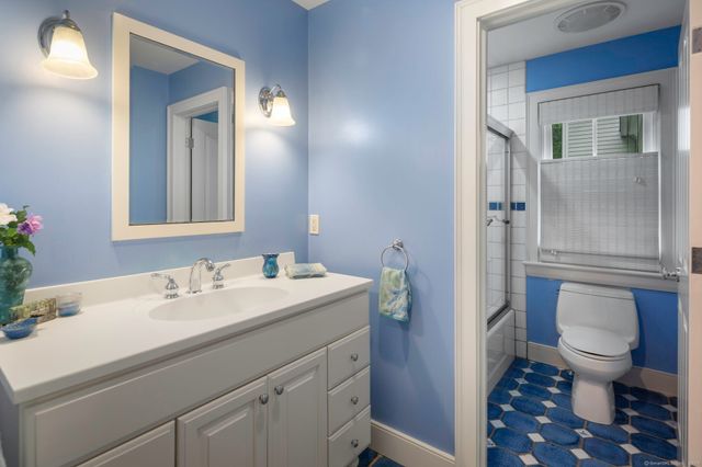 a bathroom with a sink toilet and shower