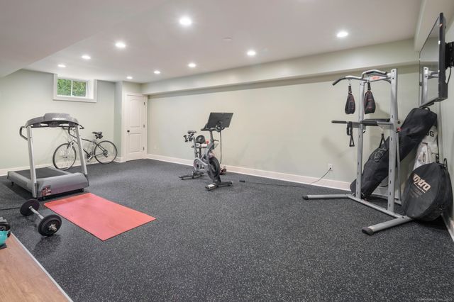 a room with gym equipment and windows