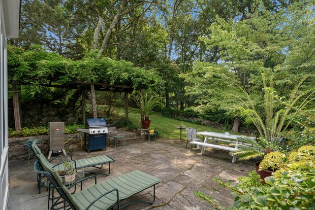 a view of backyard with seating area and green space