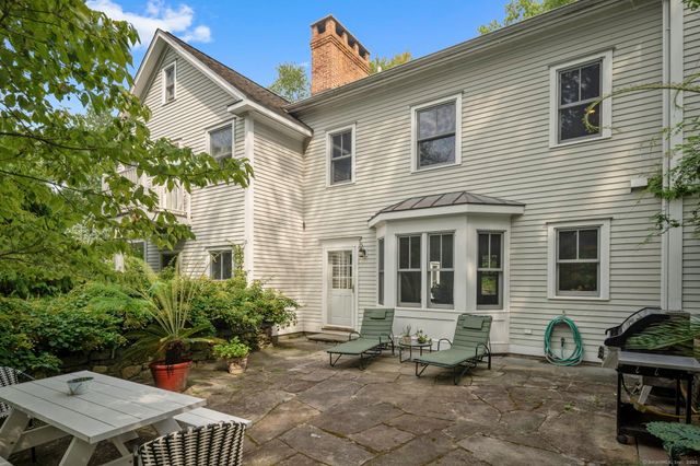 a backyard of a house with outdoor seating