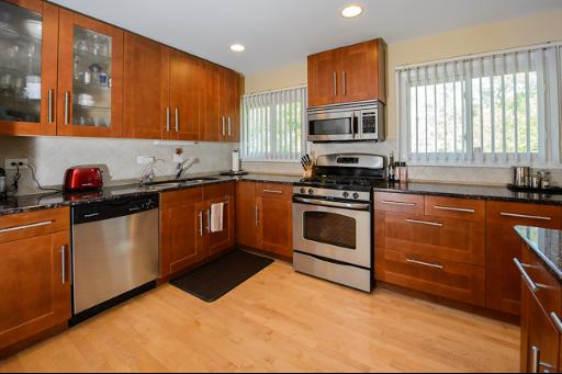 230 North Ela Road Barrington, IL 60010 - Photo 2 of 16 a kitchen with stainless steel appliances granite countertop a stove sink and cabinets